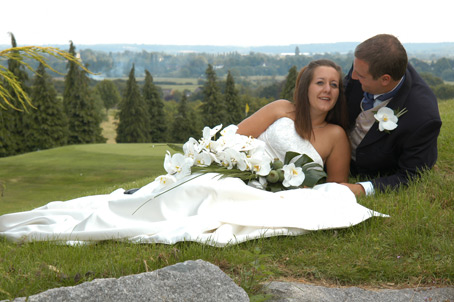 Welcombe Hotel Stratford upon Avon - liz and simon lying down golf course behind,wedding contemporary photography welcombe